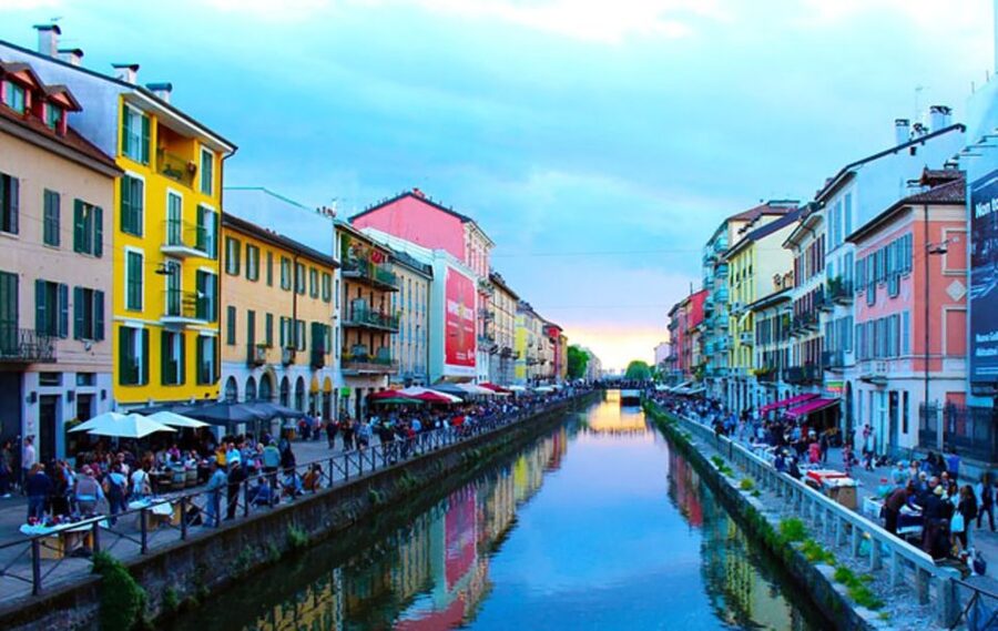 Bars and coloured houses along the Naviglio Grande canal at dusk